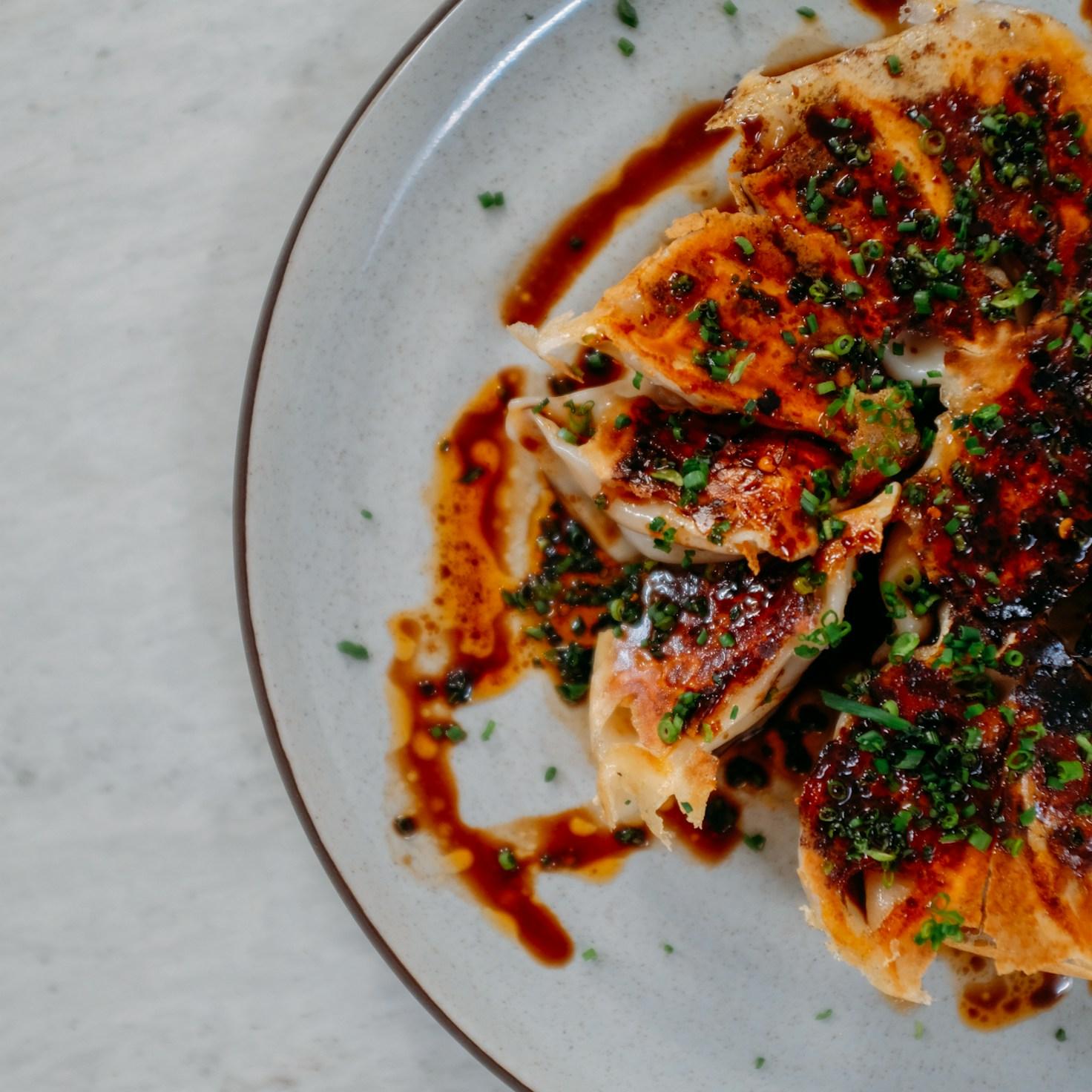 Community members collaborating in a modern kitchen space, sharing recipes and cooking techniques
